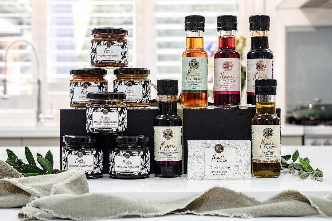 Morella Grove range of products on a worktop including chilli crunch, vinegars, oil and drizzles