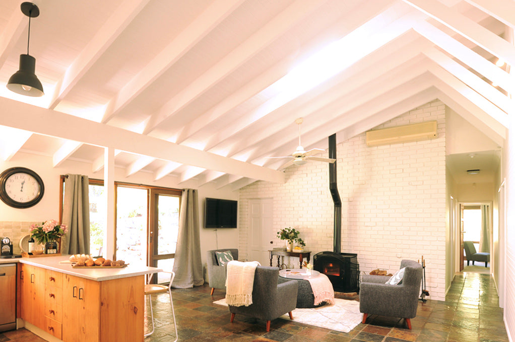 Inside the kitchen and living room area of the Morella Grove lodge that you can book a stay at in Berry