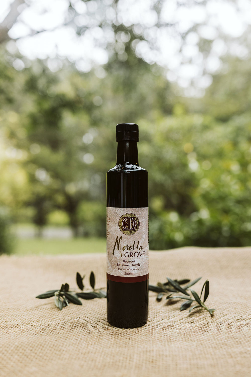 Morella Grove 500ml bottle of beetroot balsamic drizzle on a table outside