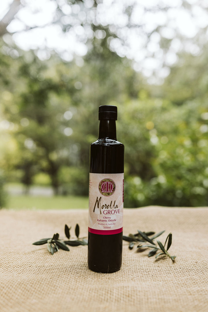 Morella Grove 500ml bottle of cherry balsamic drizzle on a table outside