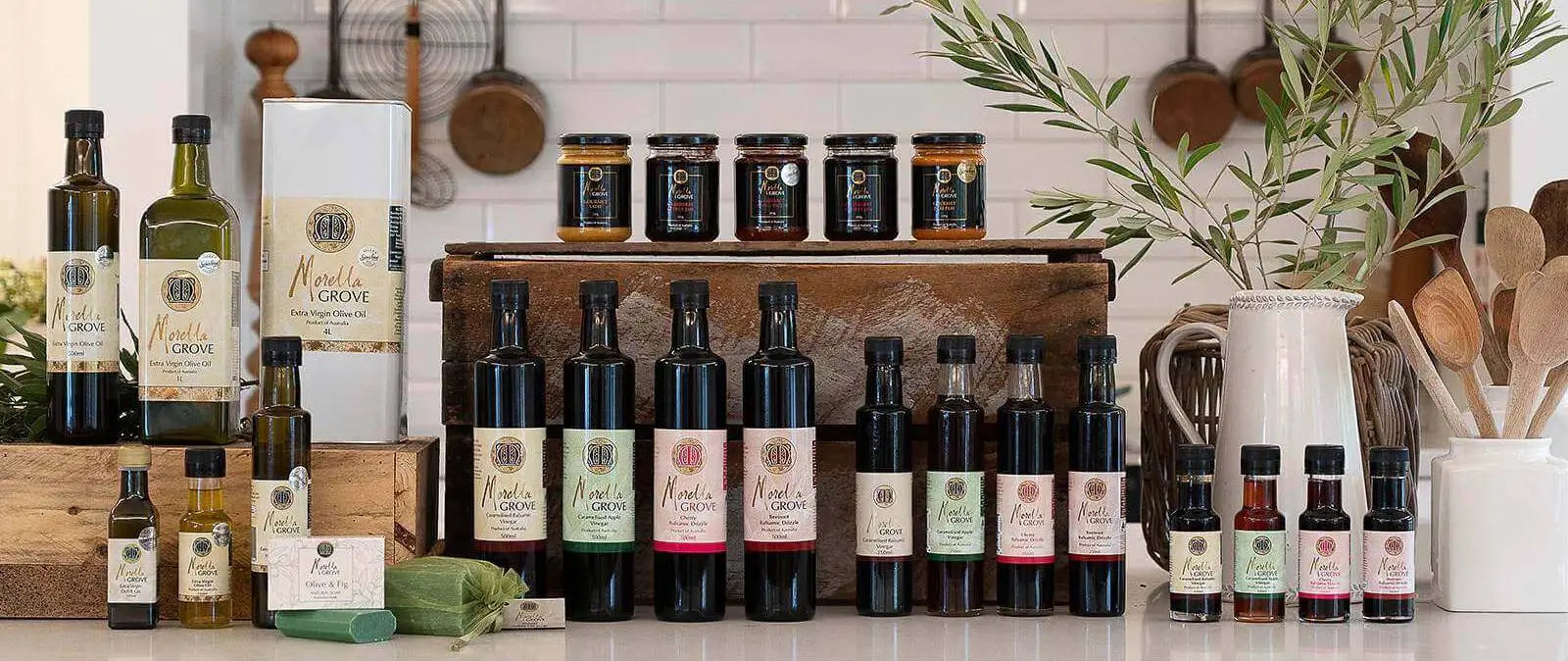 Morella Grove range of products on a worktop including sauces, vinegars, oil and drizzles in a range of sizes